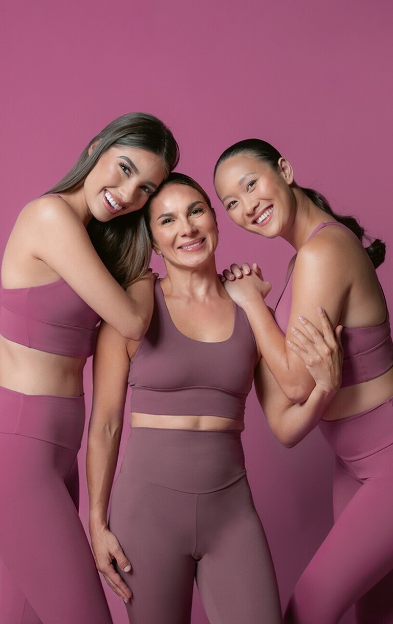 three women in pink dresses cropped